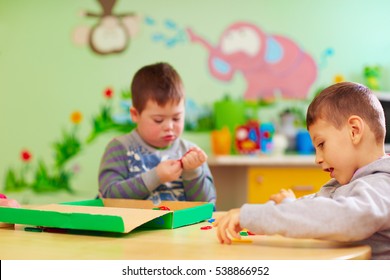 kids with special needs develop their fine motility skills in daycare rehabilitation center - Shutterstock ID 538866952