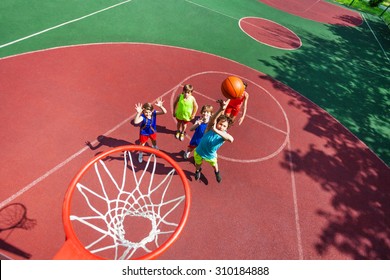 Kids stand on ground and ball flying to the basket - Powered by Shutterstock