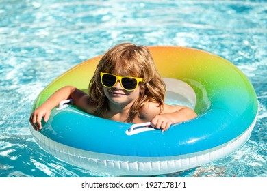 Kids Summer Weekend. Summertime Vacation. Boy In Swiming Pool. Kid At Aquapark. Happy Boy On Inflatable Rubber Circle