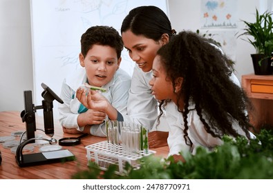 Kids, teacher and school with plants in classroom for education, science and environmental awareness. People, students and serious with test tube for crop experiment, research and knowledge at lab - Powered by Shutterstock