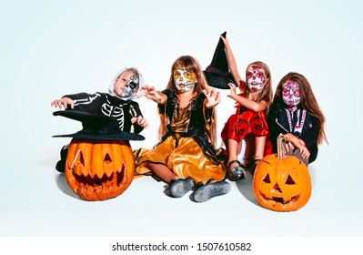 Kids or teens like witches and vampires with bones and pumpkin on white background. Caucasian models looks scary and playful. Halloween, black friday, sales, autumn holidays concept. The night of fear - Shutterstock ID 1507610582