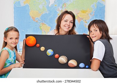 Kids With Their Science Teacher Showing Their Home Project - Planets Of The Solar System