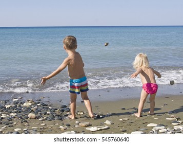 Kids Throwing Rocks In The Sea