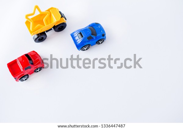 Kids toys cars frame on white background. Top
view. Flat lay. Copy space for
text