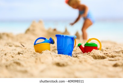 Kids Toys And Little Girl Building Sandcastle