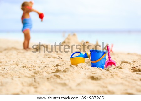 kids toys and little girl building sandcastle