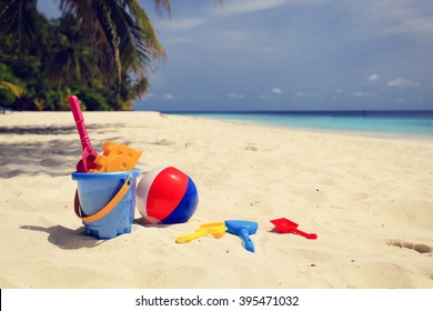 kids toys on tropical sand beach - Powered by Shutterstock