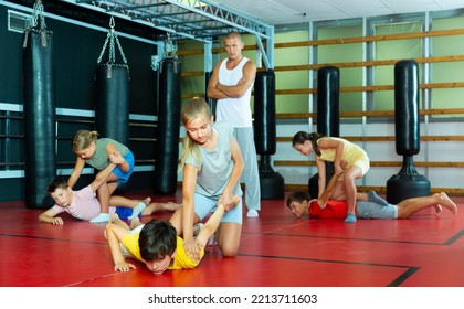 Kids training armlock move during group self-protection training. - Shutterstock ID 2213711603