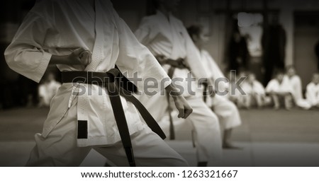 kid's training on karate-do. Banner with space for text. For web pages or advertising printing. Photo without faces, from the back.