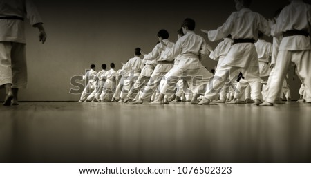 Kids training on karate-do.  Black and white. Photo without faces, from the back.