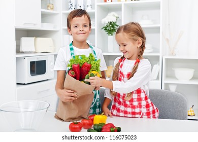 Kids Unpacking The Groceries In The Kitchen - Making Fresh Vegetables Salad