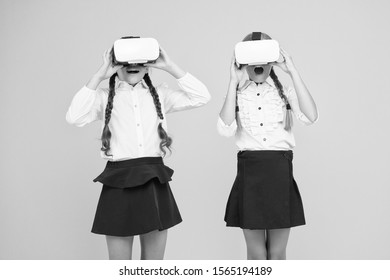 Kids use modern VR technology. Virtual reality. VR headset. Future education. Children schoolgirls wear wireless VR glasses. Exploring augmented reality. Experiences communicate and manage projects.