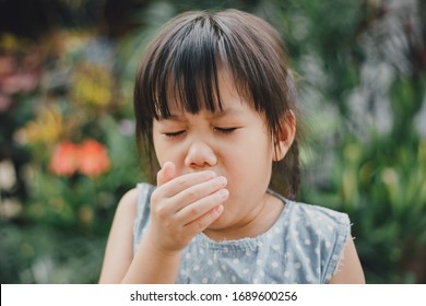 Kids Using Hand Covering Her Mouth While Cough Which Is Incorrect Sneezing Posture. Concept Of Stop And Prevention Covid-19 Or Coronavirus Spreading.