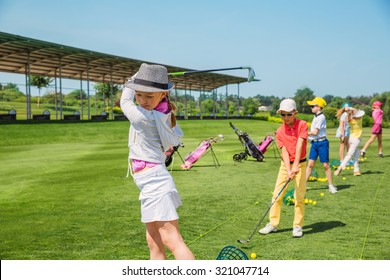 Kids warming up at golf school at summer day