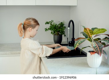 Kids Washing Dishes At The Kitchen Sin