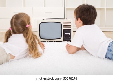 Kids Watching Old Television Set Laying On The Floor