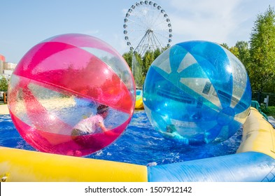kids in water balloons zorb on the water