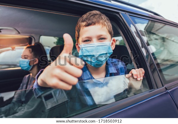 Kids
wearing anti virus masks and using digital tablets in the car. Kids
are travelling in car during coronavirus
outbreak