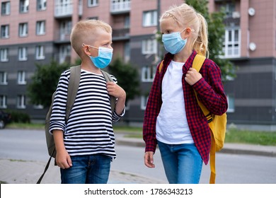 Kids Wearing Mask And Backpacks Protect And Safety From Coronavirus For Back To School. Brother And Sister Going School After Pandemic Over. Students Are Ready For New School Year.