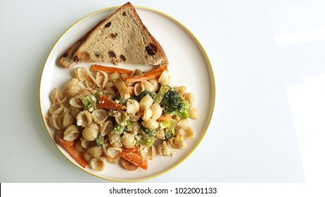 Kids weekend lunch with veggie pasta and toasted bread - Powered by Shutterstock