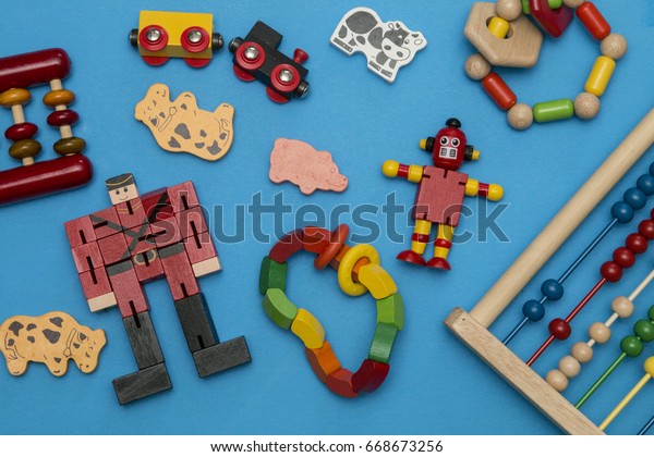 kids wooden toys\
scattered on blue\
background