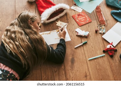 Kids Writing Christmas Cards On Wooden Floor