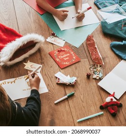 Kids writing Christmas cards on wooden floor - Powered by Shutterstock