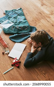 Kids Writing Christmas Cards On Wooden Floor