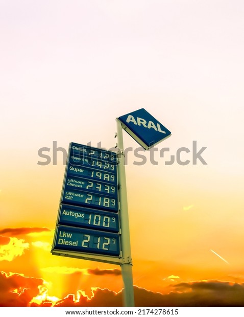 Kiel, Germany - 01.July 2022: Logo and fuel\
prices of ARAL in Germany at sunset. Aral is a brand of automobile\
fuels and petrol stations