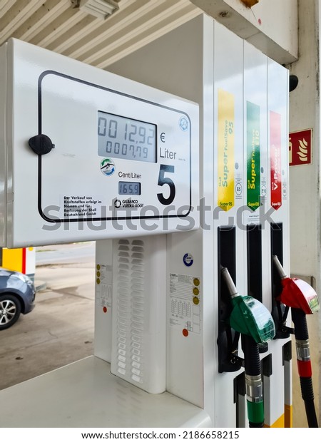 Kiel, Germany - 04. August\
2022: Petrol pump of a Shell brand petrol station filling up with\
petrol