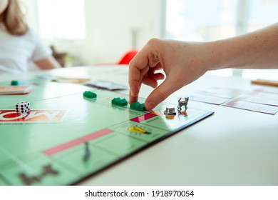 KIEL, GERMANY - 14 February 2021: Hands With Money Of Happy Children Having Fun Playing Board Game In Cozy Family Time With Their Parents