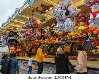 Kiel, Germany 18.6.2022 Families And Friends Playing Throwing Games In Amusement Park. People Trying To Win Stuffed Animals In Local Fair.