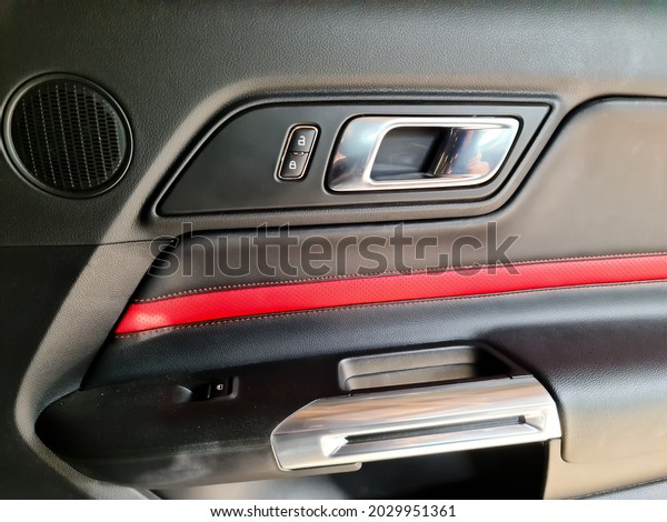 KIEL, GERMANY - Aug 13, 2021: The\
inner side of the door of a black Ford Mustang Model\
2018