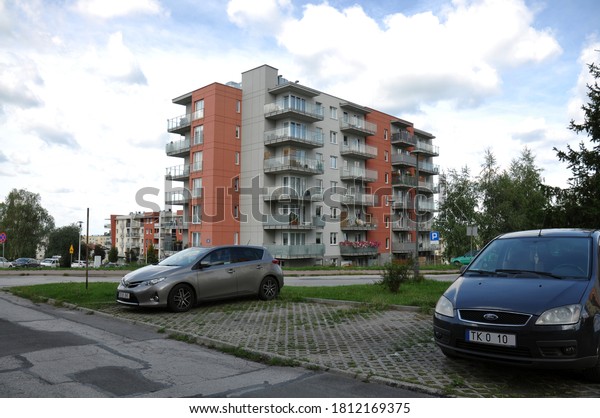 Kielce, Świętokrzyskie / Poland 2020-09-10 New\
housing development and parked cars in the parking lot nearby (part\
of registration cars\
erased)