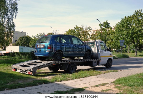Kielce, Świętokrzyskie\
/ Poland 2020-09-19 Car transporter carrying a passenger car parked\
near the road