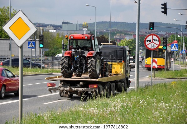 Kielce, Świętokrzyskie, Poland - 2021-05-20 - A
tow truck carrying a large
tractor