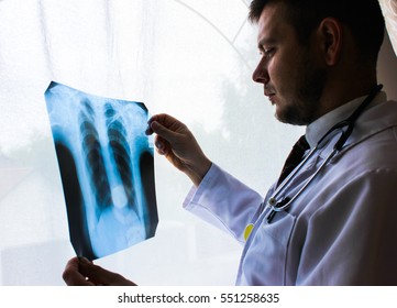 Kiev Region, Ukraine - October 12.2016: Dr. Therapist In An Office Looking X-ray The Patient's Lungs