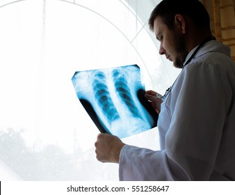 Kiev Region, Ukraine - October 12.2016: Dr. Therapist In An Office Looking X-ray The Patient's Lungs