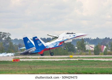 Kiev Region, Ukraine - October 2, 2010: Sukhoi Su-30LL Fighter Plane In Russian Flag Colors Is Landing With Smoke On The Runway Holding The Nose Up