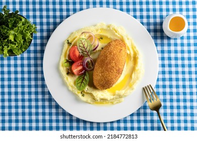 Kiev style chicken cutlet) served with mashed potatoes and vegetables on the background is blue in a cell. top view, food menu. - Powered by Shutterstock