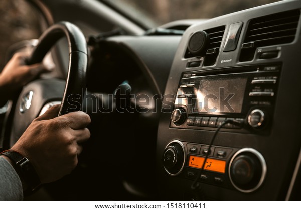 Kiev, Ukraine - 07.09.2019. Car driver\
electric Nissan leaf. Road traffic. Taxi transport Hands on\
steering wheel driving a car.\
Transportation.
