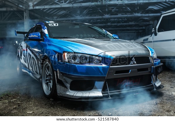 Kiev, Ukraine - 14 May 2014:\
Mitsubishi Lancer Evolution X tuning sport-car. It colored in blue,\
gray, whites colors with patterns and prints. Editorial\
photo.