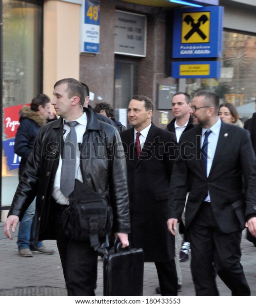 KIEV, UKRAINE - 22 FEBRUARY 2013: Minister of
Foreign affairs of Poland Radoslaw Sikorski and ambassador in
Ukraine H.Litwin with bodyguards walk on city street on February
22, 2013 in Kiev, Ukraine