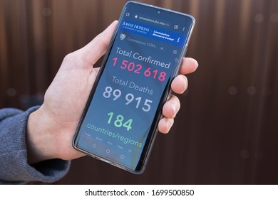 Kiev, Ukraine - 29 March 2020: Smartphone with updated Coronavirus COVID-19 live statistic of confirmed cases and world map of infected states. Johns hopkins university - Shutterstock ID 1699500850