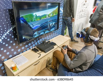 KIEV, UKRAINE - APRIL 07, 2017: Boy Using Virtual Reality Game Glasses And Joystick On Nomi Booth At 2nd International Trade Show Of Electric And Hybrid Vehicles Plug-In Ukraine In KyivExpoPlaza Venue