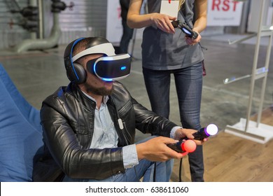 KIEV, UKRAINE - APRIL 07, 2017: Man Using Virtual Reality Game Glasses And Hand Controlers At 2nd International Trade Show Of Electric And Hybrid Vehicles Plug-In Ukraine In KyivExpoPlaza Venue.