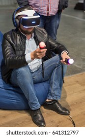 KIEV, UKRAINE - APRIL 07, 2017: Man Use Virtual Reality Game Glasses And Hand Controlers At 2nd International Trade Show Of Electric And Hybrid Vehicles Plug-In Ukraine In KyivExpoPlaza Venue.