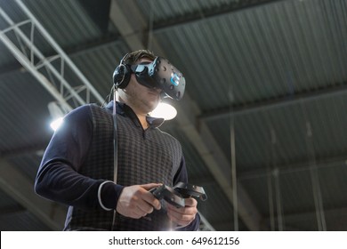 KIEV, UKRAINE - APRIL 07, 2017: Man Use Virtual Reality Game Glasses And Hand Controllers At 2nd International Trade Show Of Electric And Hybrid Vehicles Plug-In Ukraine In KyivExpoPlaza Venue.