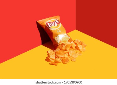 Kiev, Ukraine - April 16, 2020: Open Packet Of Lays Chips On A Red-yellow Background