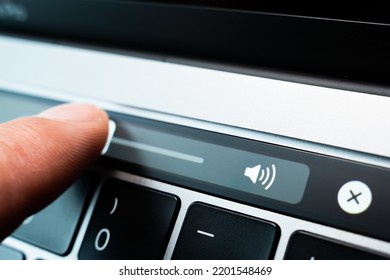 Kiev, Ukraine - August 9, 2022: Finger Adjust Volume Slider On Touch Bar Apple Macbook Pro Closeup